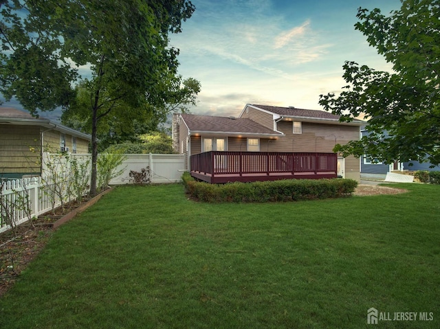 view of yard featuring a fenced backyard and a wooden deck