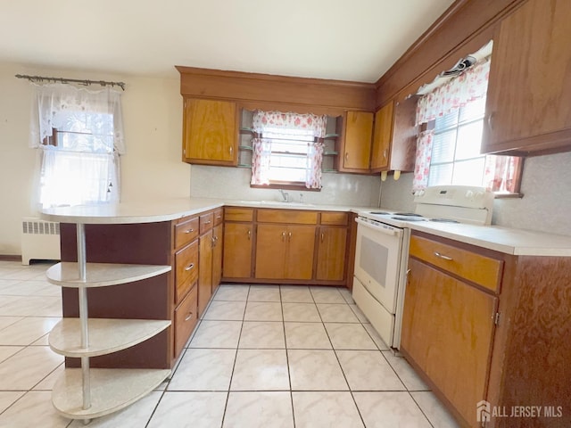 kitchen featuring open shelves, light countertops, radiator heating unit, and electric stove