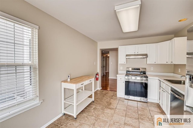 1804 Pheasant Run, South Brunswick, NJ 08852 - kitchen featuring appliances with stainless steel finishes, under cabinet range hood, a sink, light countertops, and white cabinets