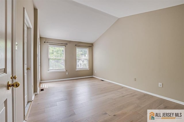 1804 Pheasant Run, South Brunswick, NJ 08852 - empty room featuring lofted ceiling, light wood-style flooring, and baseboards
