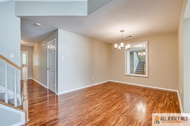 1804 Pheasant Run, South Brunswick, NJ 08852 - spare room featuring stairway, wood finished floors, a chandelier, and baseboards