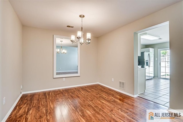 1804 Pheasant Run, South Brunswick, NJ 08852 - empty room with a chandelier, wood finished floors, and baseboards
