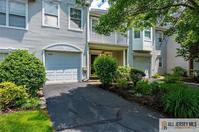 1804 Pheasant Run, South Brunswick, NJ 08852 - view of property with a garage, driveway, and a balcony