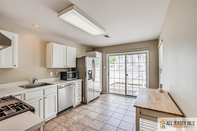 1804 Pheasant Run, South Brunswick, NJ 08852 - kitchen with stainless steel appliances, light countertops, a sink, white cabinets, and light tile patterned floors