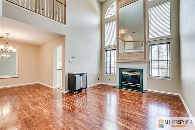 1804 Pheasant Run, South Brunswick, NJ 08852 - unfurnished living room with a towering ceiling, wood finished floors, and plenty of natural light