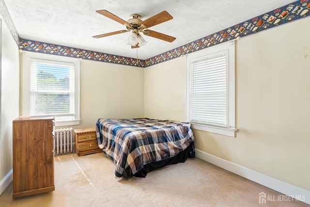 139 Palmer Ave, South Plainfield, NJ 07080 - bedroom with radiator heating unit, a textured ceiling, light carpet, and a ceiling fan