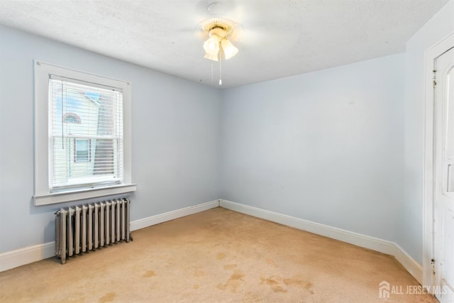 139 Palmer Ave, South Plainfield, NJ 07080 - carpeted empty room with radiator heating unit and ceiling fan
