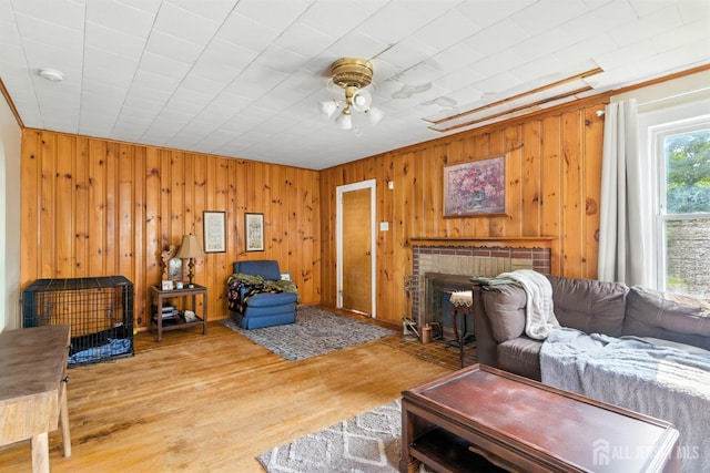 139 Palmer Ave, South Plainfield, NJ 07080 - living area with ceiling fan, a brick fireplace, wood finished floors, and wooden walls