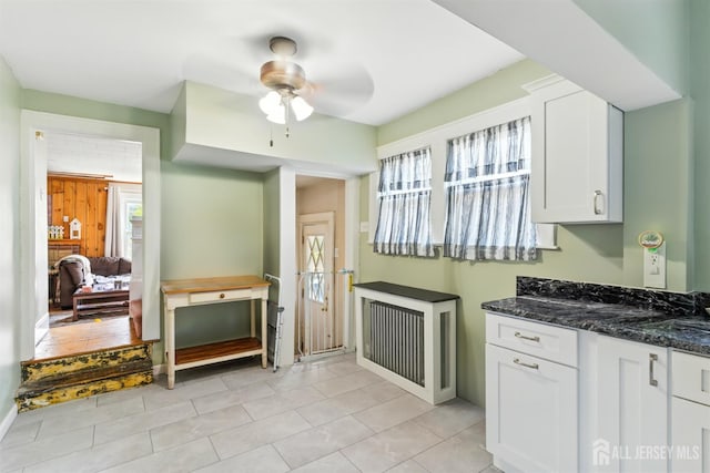 139 Palmer Ave, South Plainfield, NJ 07080 - kitchen featuring a ceiling fan, white cabinets, dark stone countertops, and light tile patterned flooring