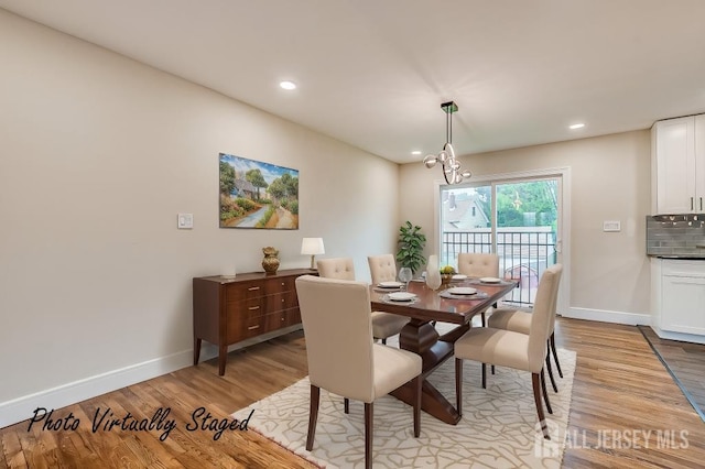 dining area with light wood-type flooring, baseboards, a chandelier, and recessed lighting
