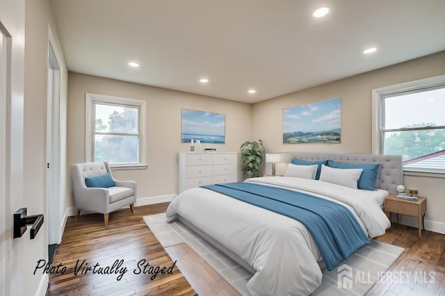 bedroom with baseboards, recessed lighting, and wood finished floors