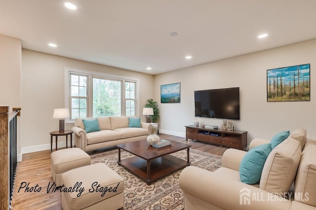 living area featuring light wood-type flooring, baseboards, and recessed lighting