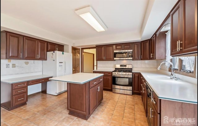 6 Persimmon Ct, East Brunswick, NJ 08816 - kitchen with appliances with stainless steel finishes, tasteful backsplash, light countertops, and a kitchen island
