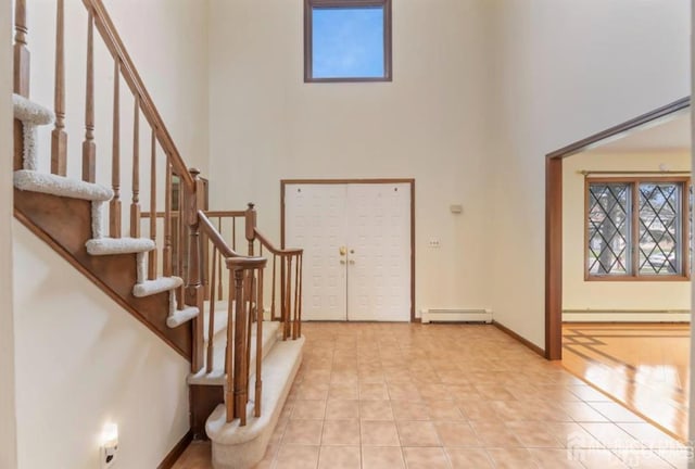 6 Persimmon Ct, East Brunswick, NJ 08816 - entrance foyer featuring a towering ceiling, a baseboard heating unit, stairs, and light tile patterned floors