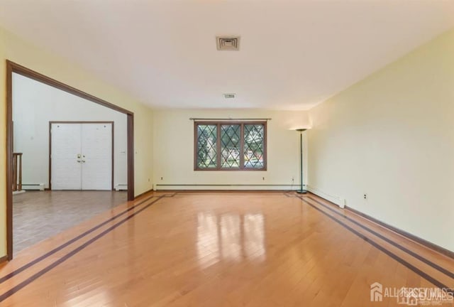 6 Persimmon Ct, East Brunswick, NJ 08816 - spare room featuring wood-type flooring and a baseboard radiator