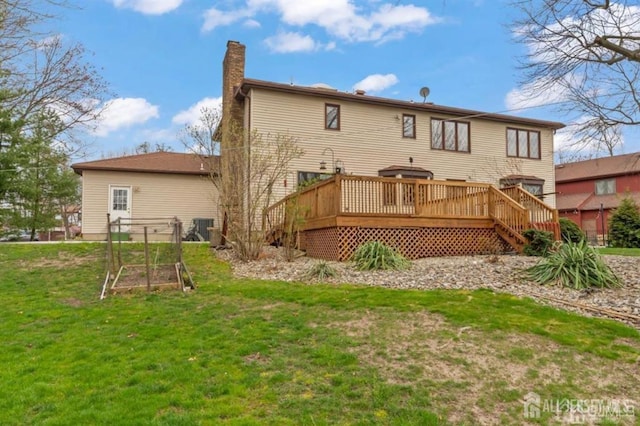 6 Persimmon Ct, East Brunswick, NJ 08816 - back of house featuring a chimney, a wooden deck, a lawn, a vegetable garden, and stairs