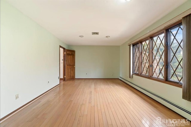6 Persimmon Ct, East Brunswick, NJ 08816 - spare room with a baseboard heating unit and light wood-style floors