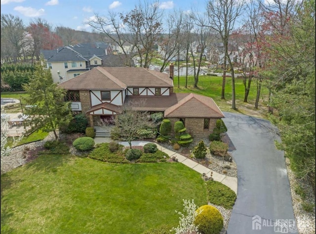 6 Persimmon Ct, East Brunswick, NJ 08816 - view of front of property with a chimney, a front yard, roof with shingles, and a residential view
