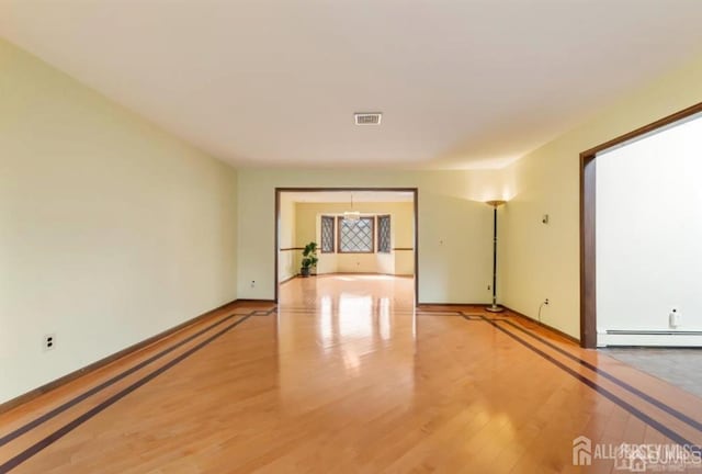 6 Persimmon Ct, East Brunswick, NJ 08816 - empty room featuring light wood-style flooring and baseboard heating