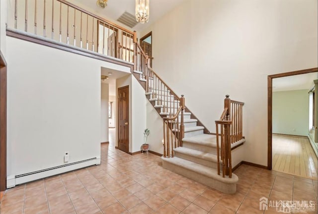 6 Persimmon Ct, East Brunswick, NJ 08816 - stairs with a baseboard heating unit, a high ceiling, tile patterned flooring, and a chandelier