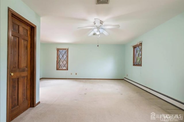 6 Persimmon Ct, East Brunswick, NJ 08816 - empty room featuring a baseboard heating unit, carpet, and a ceiling fan