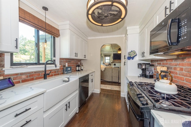 33 Orchard Rd, Middlesex, NJ 08846 - kitchen featuring black appliances, dark wood-style flooring, white cabinets, a sink, and light stone counters