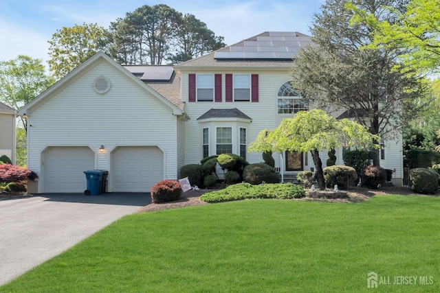 35 Spruce Meadows Dr, Monroe, NJ 08831 - view of front facade featuring a front yard, a shingled roof, roof mounted solar panels, asphalt driveway, and a garage
