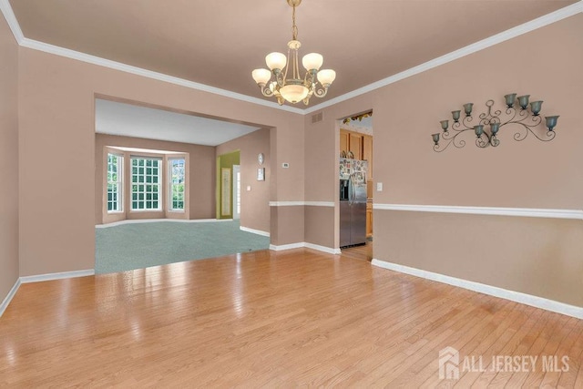 35 Spruce Meadows Dr, Monroe, NJ 08831 - spare room with a chandelier, light wood-style flooring, and crown molding