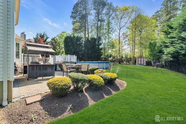 35 Spruce Meadows Dr, Monroe, NJ 08831 - view of yard featuring a storage shed, an outdoor pool, a patio area, a gazebo, and view of scattered trees