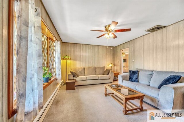 living room with ceiling fan and plenty of natural light