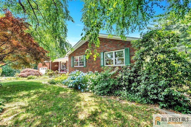 view of property exterior with a yard