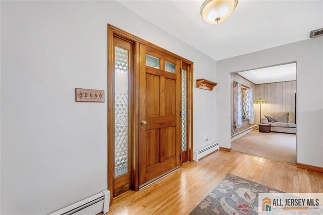 foyer featuring a baseboard heating unit and light wood-type flooring