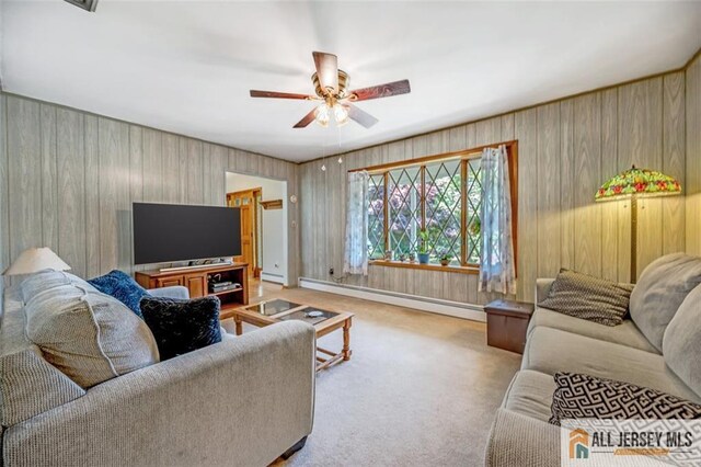 carpeted living room with ceiling fan and baseboard heating