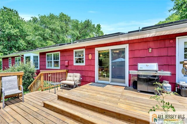 wooden terrace featuring grilling area