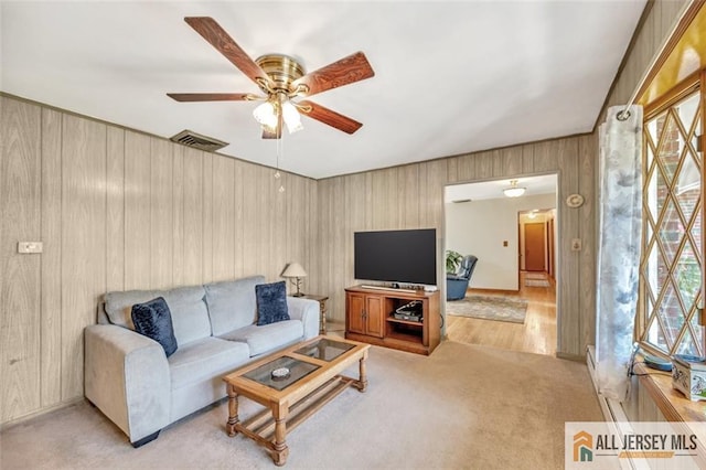 carpeted living room featuring ceiling fan