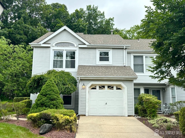 207 Manahan Rd, East Brunswick, NJ 08816 - view of front facade with roof with shingles, a garage, and concrete driveway