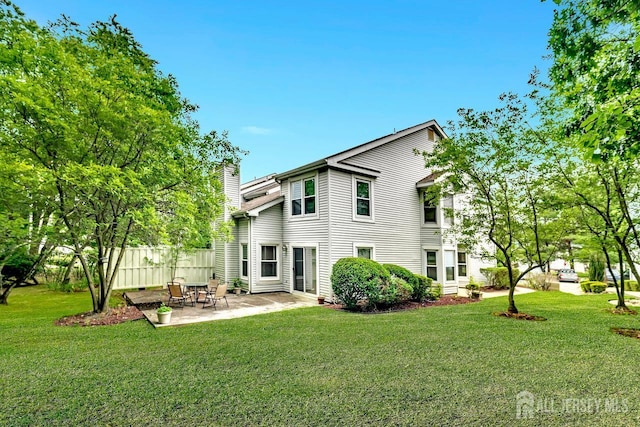 207 Manahan Rd, East Brunswick, NJ 08816 - rear view of house with a chimney and a patio area