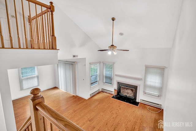 207 Manahan Rd, East Brunswick, NJ 08816 - unfurnished living room featuring high vaulted ceiling, a ceiling fan, wood finished floors, a baseboard radiator, and a fireplace with flush hearth