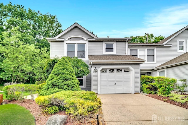 207 Manahan Rd, East Brunswick, NJ 08816 - traditional-style home featuring concrete driveway, an attached garage, and roof with shingles