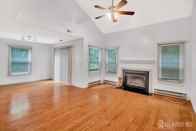 207 Manahan Rd, East Brunswick, NJ 08816 - unfurnished living room with a baseboard heating unit, wood finished floors, ceiling fan, a fireplace with flush hearth, and high vaulted ceiling