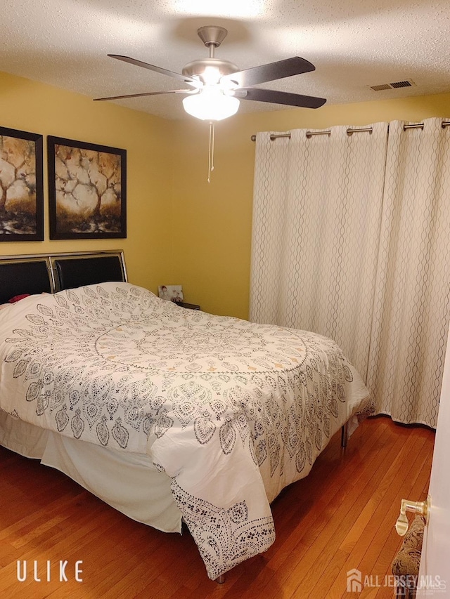 156 Nebula Rd, Piscataway, NJ 08854 - bedroom with wood-type flooring, a textured ceiling, and ceiling fan