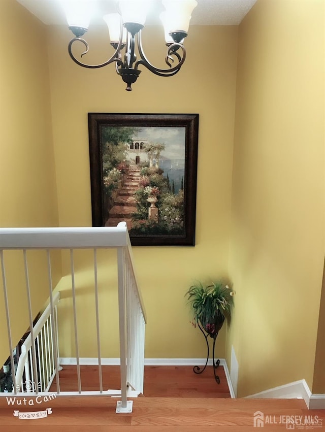 156 Nebula Rd, Piscataway, NJ 08854 - stairway with a chandelier and wood finished floors