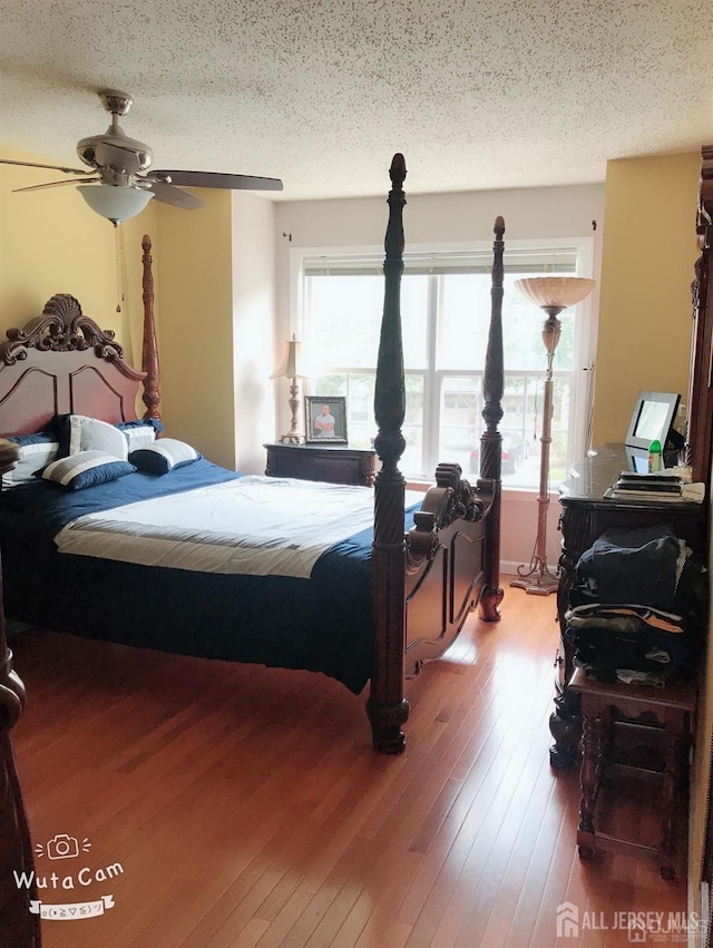 156 Nebula Rd, Piscataway, NJ 08854 - bedroom featuring multiple windows, wood-type flooring, a textured ceiling, and a ceiling fan