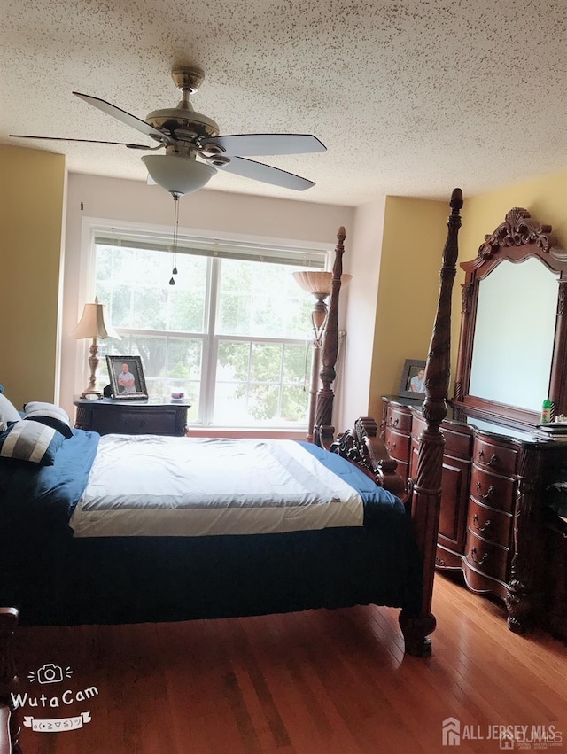 156 Nebula Rd, Piscataway, NJ 08854 - bedroom featuring multiple windows, light wood-style floors, a ceiling fan, and a textured ceiling