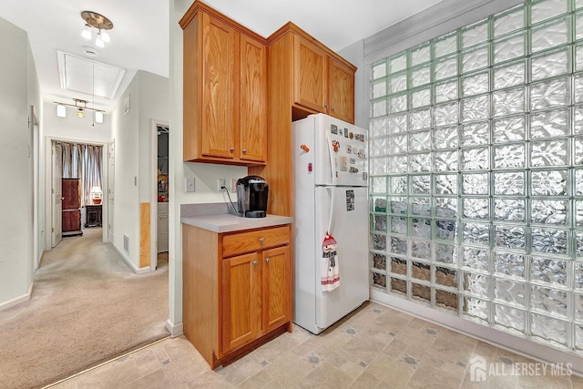 32 Prusakowski Blvd, Sayreville, NJ 08859 - kitchen with freestanding refrigerator, light countertops, and brown cabinets