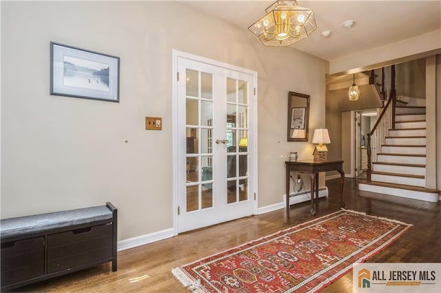 doorway to outside with french doors, a baseboard radiator, and wood-type flooring