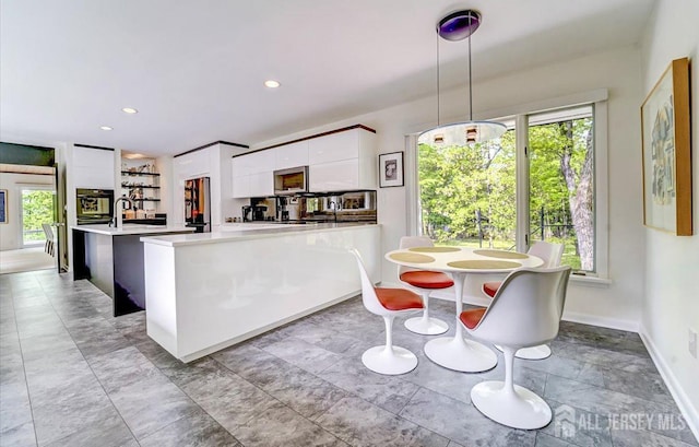 1580 Mountain Top Rd, Bridgewater, NJ 08807 - kitchen featuring fridge, modern cabinets, light countertops, white cabinetry, and plenty of natural light