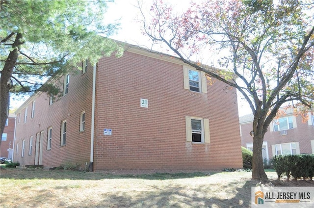 view of side of home with a yard