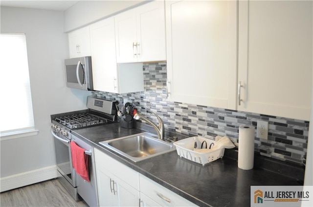 kitchen featuring sink, stainless steel appliances, and white cabinets