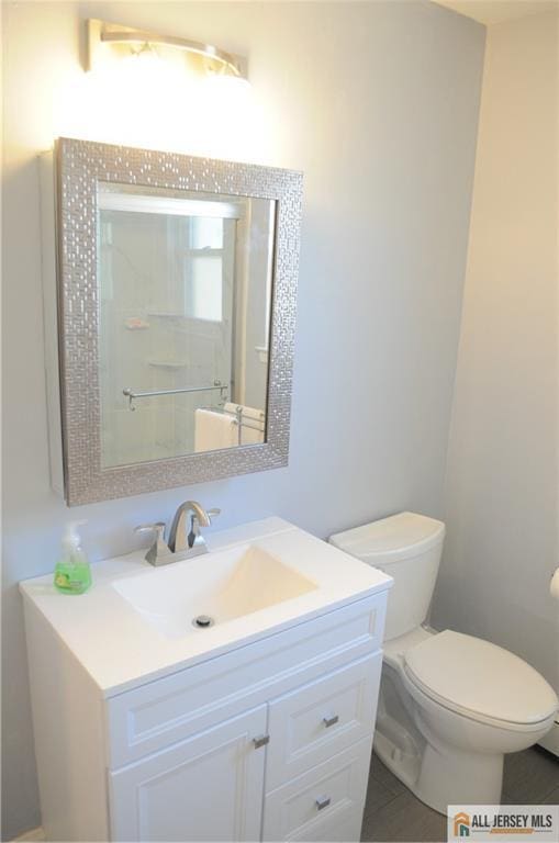 bathroom featuring vanity and toilet